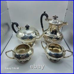 A silver plated three piece tea set together with a similar plated coffee pot