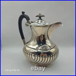 A silver plated three piece tea set together with a similar plated coffee pot