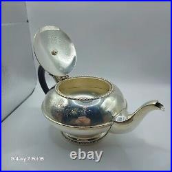 A silver plated three piece tea set together with a similar plated coffee pot