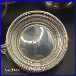 A silver plated three piece tea set together with a similar plated coffee pot