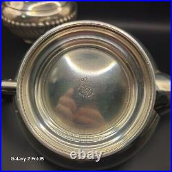 A silver plated three piece tea set together with a similar plated coffee pot